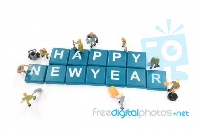 Miniature Worker Team Building Word Happy New Year On White Background Stock Photo