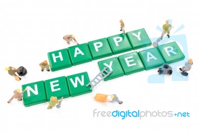 Miniature Worker Team Building Word Happy New Year On White Background Stock Photo