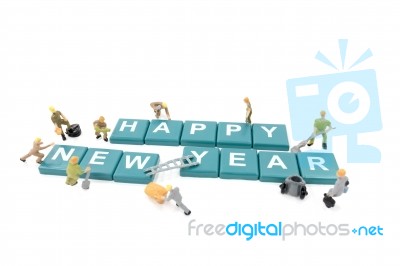 Miniature Worker Team Building Word Happy New Year On White Background Stock Photo