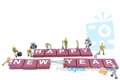 Miniature Worker Team Building Word Happy New Year On White Background Stock Photo