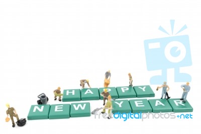 Miniature Worker Team Building Word Happy New Year On White Background Stock Photo