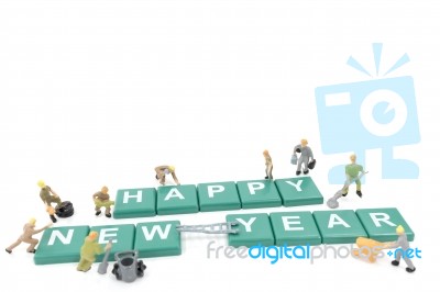 Miniature Worker Team Building Word Happy New Year On White Background Stock Photo