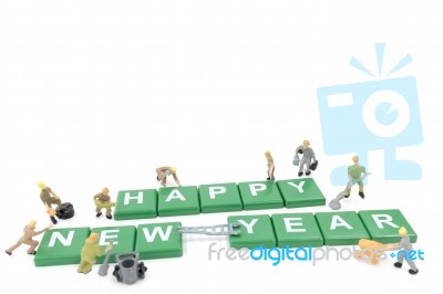 Miniature Worker Team Building Word Happy New Year On White Background Stock Photo