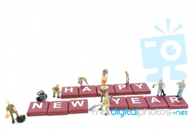 Miniature Worker Team Building Word Happy New Year On White Background Stock Photo