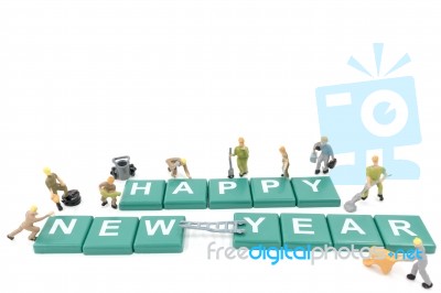 Miniature Worker Team Building Word Happy New Year On White Background Stock Photo