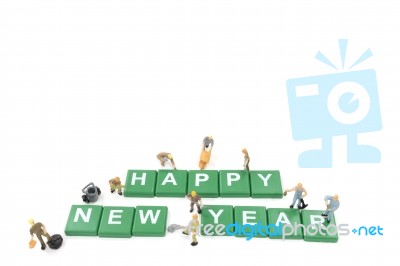 Miniature Worker Team Building Word Happy New Year On White Background Stock Photo