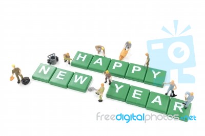 Miniature Worker Team Building Word Happy New Year On White Background Stock Photo