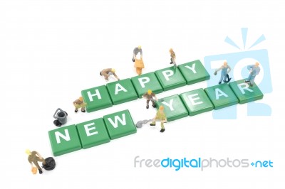 Miniature Worker Team Building Word Happy New Year On White Background Stock Photo