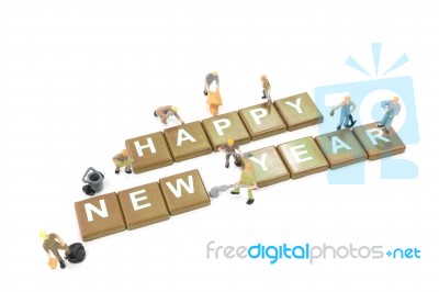 Miniature Worker Team Building Word Happy New Year On White Background Stock Photo