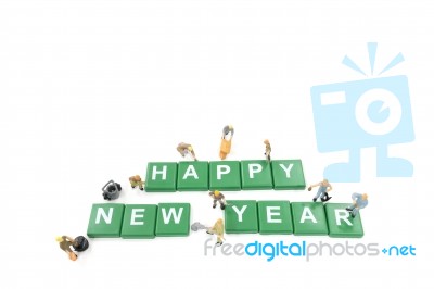 Miniature Worker Team Building Word Happy New Year On White Background Stock Photo