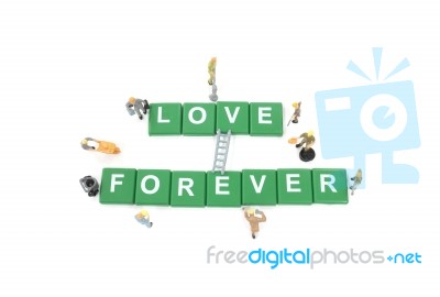 Miniature Worker Team Building Word Love Forever On White Backgr… Stock Photo