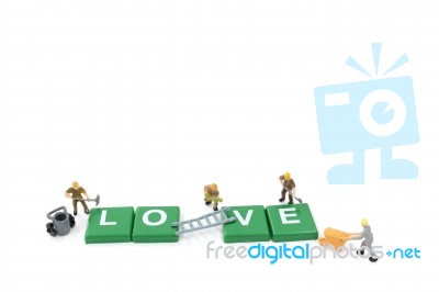 Miniature Worker Team Building Word Love On White Background Stock Photo