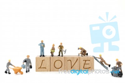 Miniature Worker Team Building Word Love On White Background Stock Photo