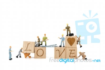 Miniature Worker Team Building Word Love On White Background Stock Photo