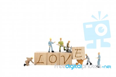 Miniature Worker Team Building Word Love On White Background Stock Photo