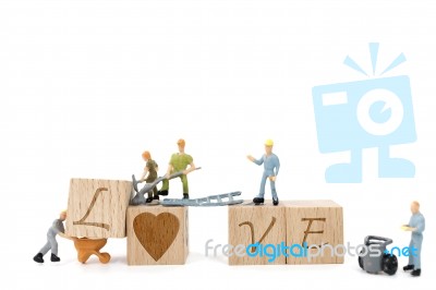 Miniature Worker Team Building Word Love On White Background Stock Photo