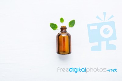 Mint Essential Oil In A Glass Bottle With Leaves On White Backgr… Stock Photo