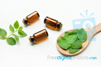 Mint Essential Oil In A Glass Bottle With Leaves On White Backgr… Stock Photo