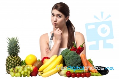 Mischievous Look Of A Young Woman With Fruits Stock Photo