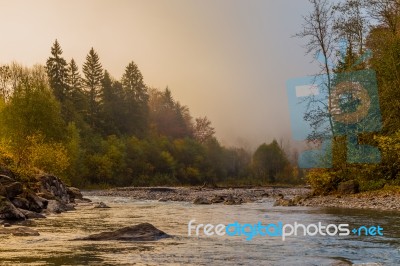 Misty River In The Alps Stock Photo