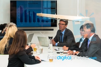 Mixed Group In Business Meeting Seen Through Glass Door Stock Photo