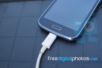 Mobile Phone Charging With Solar Energy - Charger Stock Photo