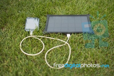 Mobile Phone Charging With Solar Energy - Charger Stock Photo