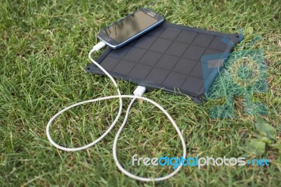 Mobile Phone Charging With Solar Energy - Charger Stock Photo