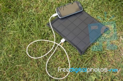 Mobile Phone Charging With Solar Energy - Charger Stock Photo