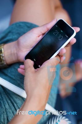 Mobile Phone In A Woman's Hand In The City At Night Stock Photo