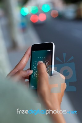 Mobile Phone In A Woman's Hand In The City At Night Stock Photo