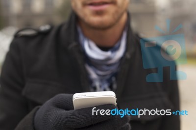 Mobile Phone In Hands With Glowes, Cold Weather Stock Photo