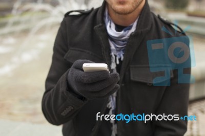 Mobile Phone In Hands With Glowes, Cold Weather Stock Photo