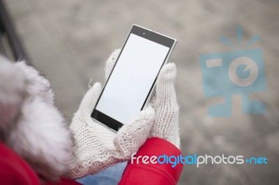 Mobile Phone In Hands With Glowes, Cold Weather Stock Photo