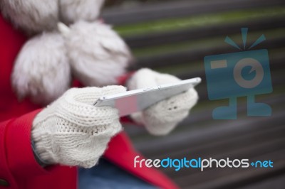 Mobile Phone In Hands With Glowes, Cold Weather Stock Photo