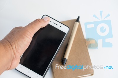 Mobile Phone Notebook And Pen On White Background Stock Photo