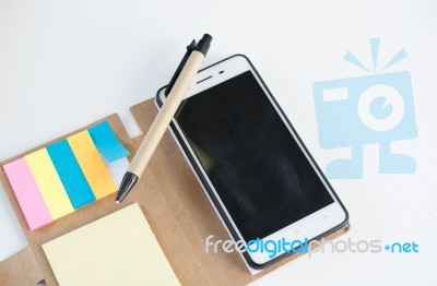 Mobile Phone Notebook And Pen On White Background Stock Photo