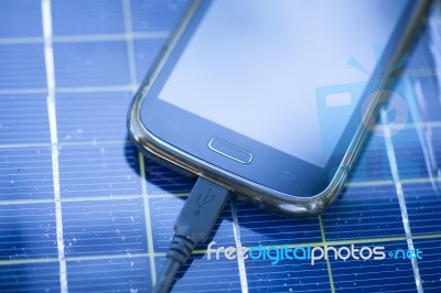 Mobile Phone On Solar Charger Stock Photo