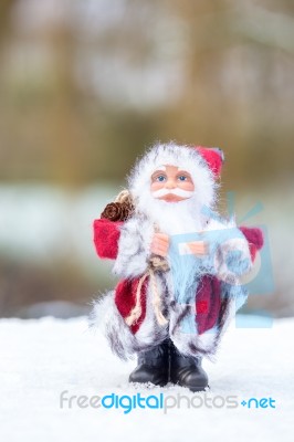 Model Of Santa Claus Standing In White Snow Outdoors Stock Photo