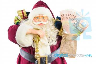 Model Of Santa Claus With Ringing Bell Gifts And Money Stock Photo