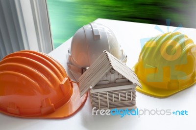 Model Of Wood House On Architect Working Table And Safety Helmet… Stock Photo