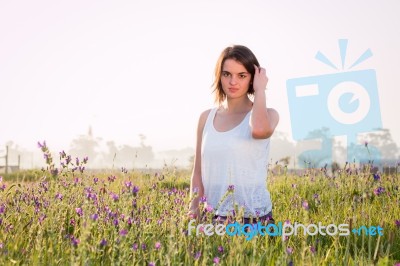 Model Sitting In Field Stock Photo