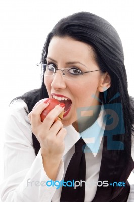 Model Wearing Spectacles Eating An Apple Stock Photo