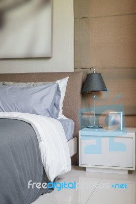 Modern Bedroom With Black Lamp On White Table Stock Photo