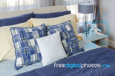 Modern Bedroom With Blue Bed And Yellow Pillows Stock Photo