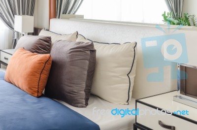 Modern Bedroom With Orange Pillow And Blue Blanket Stock Photo