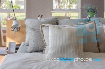 Modern Bedroom With Wooden Bed And Pillows Stock Photo