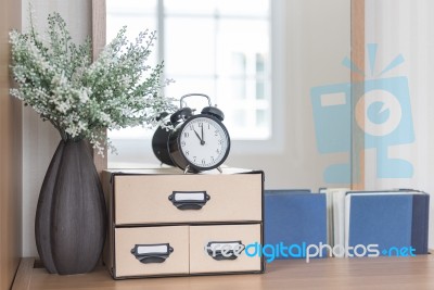 Modern Black Alarm Clock On Boxes Stock Photo