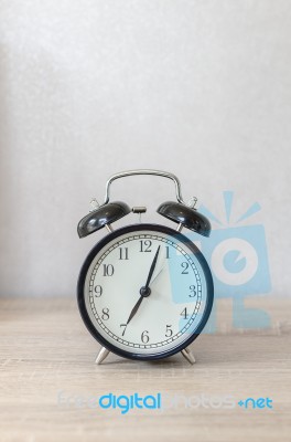 Modern Black Alarm Clock On Wooden Table Stock Photo