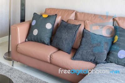 Modern Brown Sofa With Black Pillows In Living Room Stock Photo